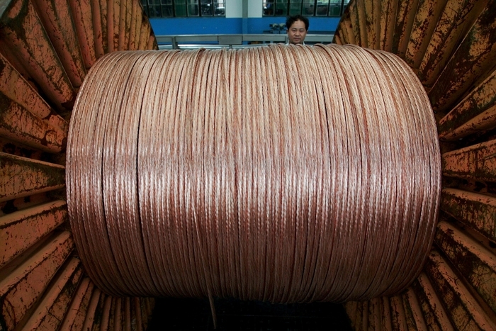 FILE PHOTO: An employee works at an electricity cable factory in Baoying, Jiangsu province, China